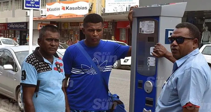 Nadi Town Council senior technician Samisoni Kuwe (right) explains to motorists about the newly installed pay and display electronic metres in Nadi Town on June 8, 2020. Photo: Waisea Nasokia