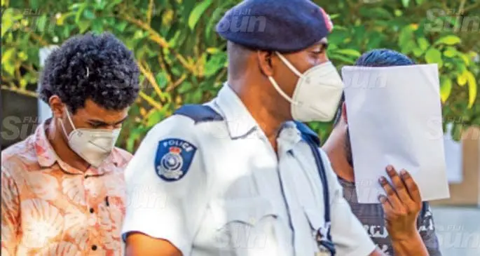 Exotic Fiji limited employees Harrish Kumar (covering his face) and Joshua Colo at the Magistrate’s Court in Suva on May 16th 2021. Photo: Leon Lord