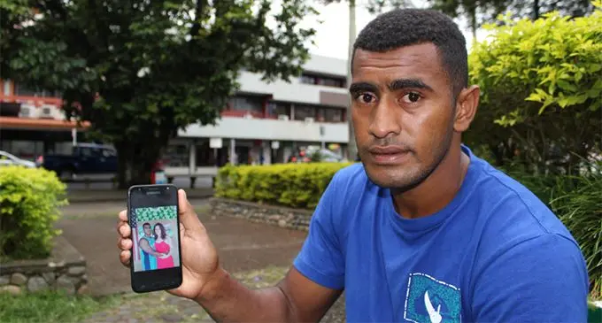 Petero Vunidilo holds up a photo of himself and his late fiance, Kathleen Canavan in Suva on June 10, 2019.  Photo: Sydnee Gonzalez