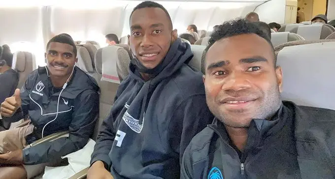 Fiji Airways Fijian 7s players from left, Filipo Bukayaro, Joseva Talacolo and Jerry Tuwai on board their flight bound for Singapore on April 4, 2022.