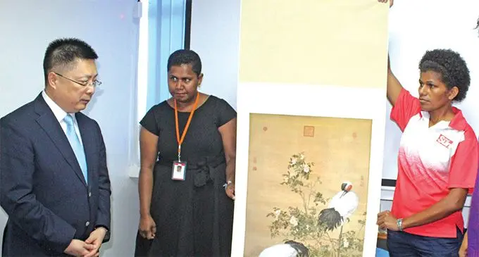 Standing from left: Chinese Ambassador to Fiji Qian Bo, Fiji Sun Managing Editor Business Maraia Vula and Deputy-Managing Editor Business Lusiana Tuimaisala.