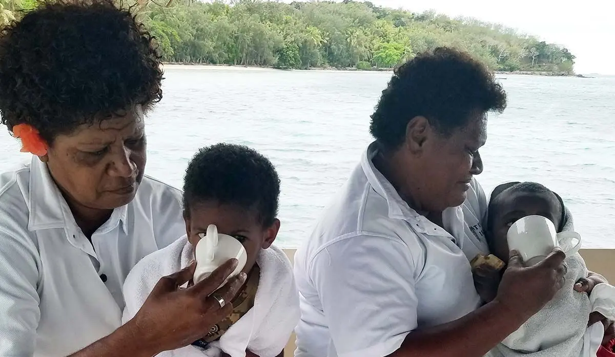 Staff of Turtle Island Resort attending to the rescued children at the resort