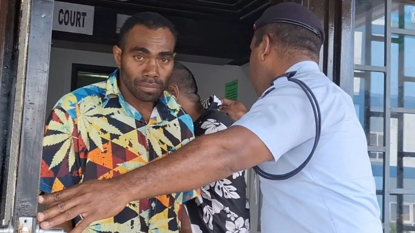 : Accused 34-year-old Keperieli Ketewai is escorted out of the Nadi Magistrates Court by a police officer. 