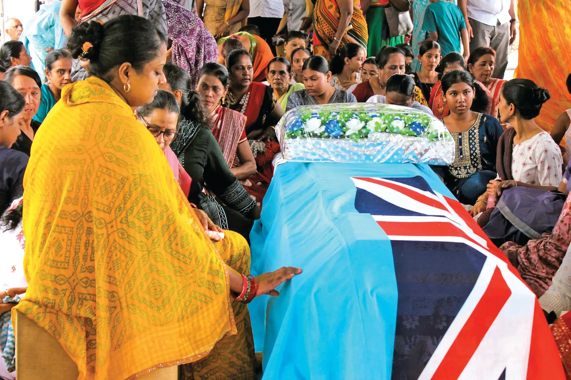 Grieving wife Ashmita Kumar sits beside the casket of her late husband, police constable Dharmesh Krishna, during his funeral service in Namara, Labasa on December 12, 2025. 