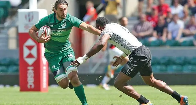 Ireland 7s prop Harry McNulty  tries to fend a Fiji Airways Fijian 7s player. Photo: Irish Times  