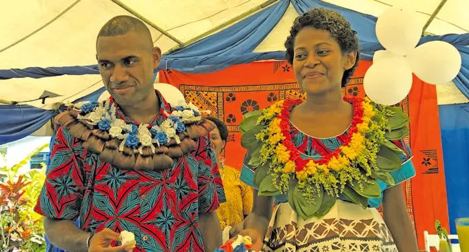 Inia Tawalo with wife Jokaveti after cutting their wedding cake at Batiri Village in Nadroga on the morning of March 9, 2018. Inset: Tawalo scores Fijian Warriors first try against Samoa A at the ANZ Stadium, Suva on March 9, 2018. Photos: Rosi Dovierata and Ronald Kumar.