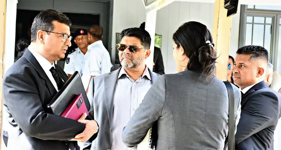 Lawyer Devanesh Sharma speaks to his clients, former Attorney-General Aiyaz Sayed-Khaiyum (facing camera), and former Supervisor of Elections Mohammed Saneem (on the right).  Photo: Ronald Kumar