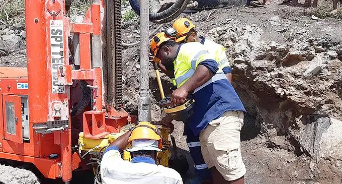 Mineral Resources Department workers carrying out the drilling process the drilling process at Daku Village in Kia Island.