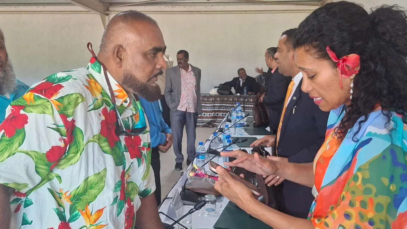 Henry Nand speaking to the Information Minister, Lynda Tabuya at the George Shiu Raj Hall in Rakiraki.