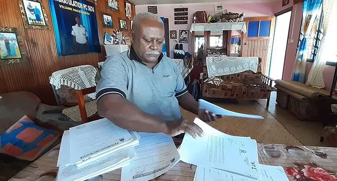 Marika Tauva at his home in Navosai showing documents he has kept in relation to the Welfare Scheme.  Photo: Shalveen Chand