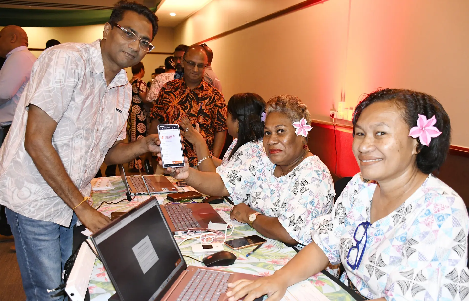 Land Transport Authority staff Talelala Maraiwai and Sera  Digogo assisted customer Avinesh Krishna to register on through LTA's revamped e-service and website following the launch in Suva on December 23, 2025. 