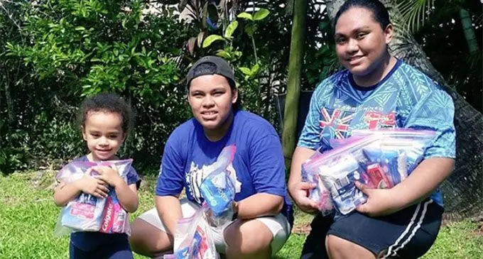 AnneMary Raduva (right) with her siblings holding the dignitary packs.  
