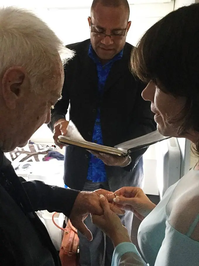 Kylie slips the ring onto Captain Seymour’s finger while celebrant Apisai Vasu looks on. 