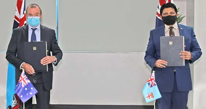 Australian High Commissioner to Fiji, John Feake with the Minister for Economy and Attorney-General, Aiyaz Sayed-Khaiyum at the signing yesterday. Photo: Department of Information