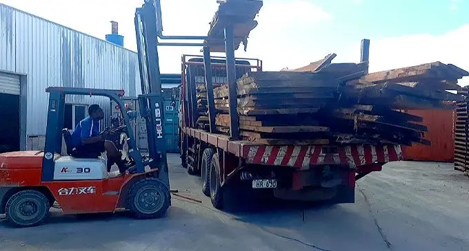 Touchwood Sawmillers Pte Ltd containers are being loaded for export to Japan.