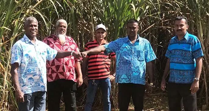 Assistant Minister for Sugar, George Vegnathan fist pump with a new cane farmer in Seaqaqa Shaan Ali while visiting his 85 acres of cane on June 19, 2020. Photo: Laisa Lui