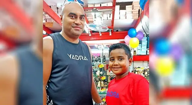 Shanton Volau buying school shoes for his son Hezekiah at Parma’s footwear. Photo: Noolyn Chand