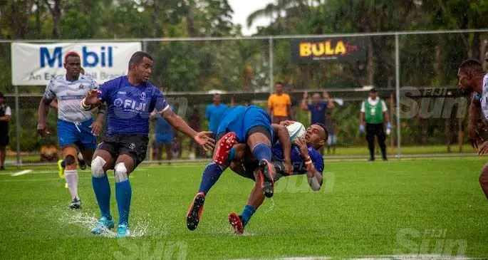 Fijian 7s rep, Sireli Maqala, is tackled by a Police player while Kitione Taliga looks on during the cup final of the Mobil Uprising 7s at Uprising Sports Centre, Pacific Harbour, on February 6, 2021. Photo: Leon Lord