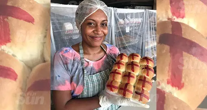 The Hot Bread Corner staff Anaseini Leleca, 25, serving customers with hot cross buns in Labasa on April 10, 2020. Photo: Shratika Naidu