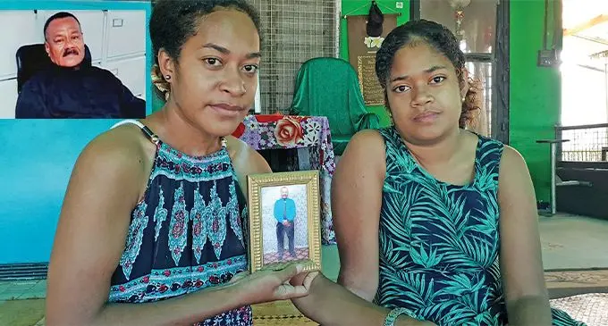 Paulini Johnson (left) and Deda Johnson (right) holding a photo of their late father, Joseph Johnson at their home at Sulua Street in Lautoka on February 20, 2022. Photo: Nicolette Chambers