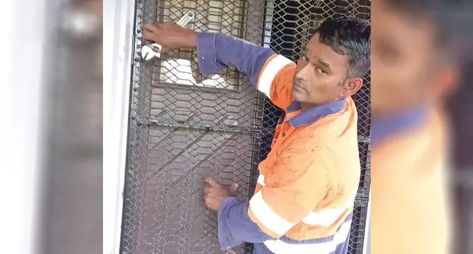 Dany Chand putting up shutters at his home in Viseisei Back Road, Lautoka, as a way to prepare for cyclone.