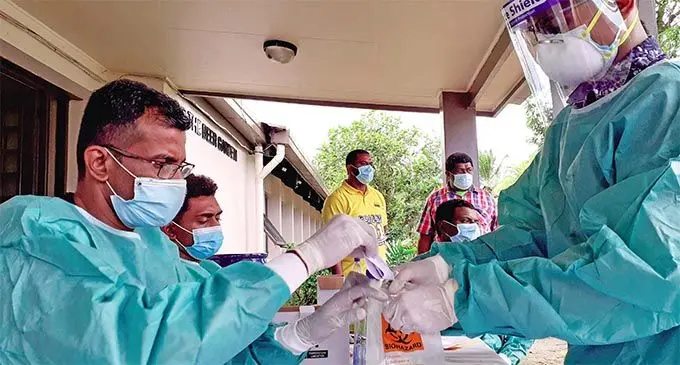 Volunteer frontliner Rakesh Kumar (left) collects data for records from the medical team at the screening clinic in Pacific Harbour on July 20, 2021. Photo: Ronald Kumar