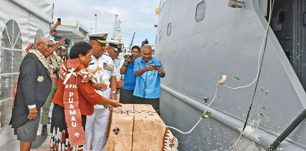 RFMF Naval Division Commander Commodore Humphrey Tawake assists Sulueti Rabuka to smash a champagne bottle against RFNS Puamau, a common naval tradition which signifies good fortune on its voyages and also for its crew members, as Prime Minister Sitiveni Rabuka and others look on. The event was held at the Stanley Brown Naval Base on May 18, 2024 Photo: DEPTFO News