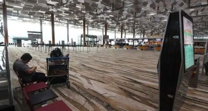 Photo taken on March 19, 2020 shows an almost empty departure hall at the Singapore Changi Airport in Singapore. (Photo by Then Chih Wey/Xinhua)