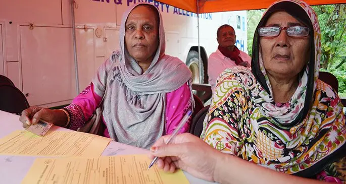 Haniffa Bi 70 (left) and Fatima Bi 69, fill in their Social Welfare assistance form at Minister for Women, Children and Poverty Alleviation Suva office on July 10. Photo: Ronald Kumar.
