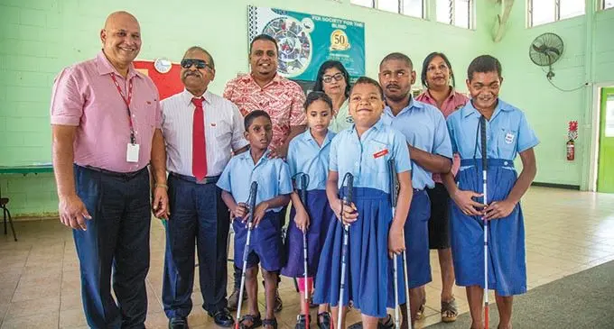 Members of the United Blind Persons of Fiji with students from School of the Blind. Fromt left;  Eugene Williams (treasurer) , Rakesh Chand (secretery) Rajnel Prasad , student Adarsh Narayan, Manu Meleti, Melaia Sewasewa, Samuela Naketeca, Barbera Farouk (executive director) Sharmila Chandra (head teacher ) and Alumita Jioji in Vatuwaqa after they were donated walking canes on April 12,  2021. Photo: Leon Lord
