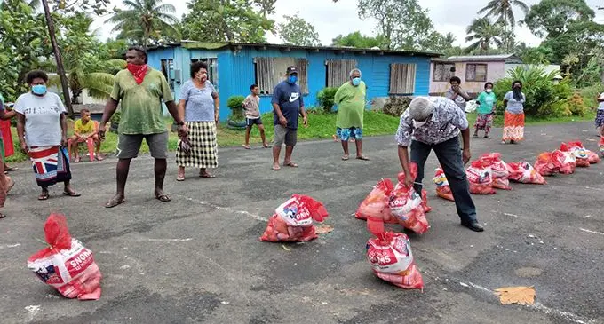 Families collect their food ration in Newtown, Nasinu from a group of friends on May 11, 2021