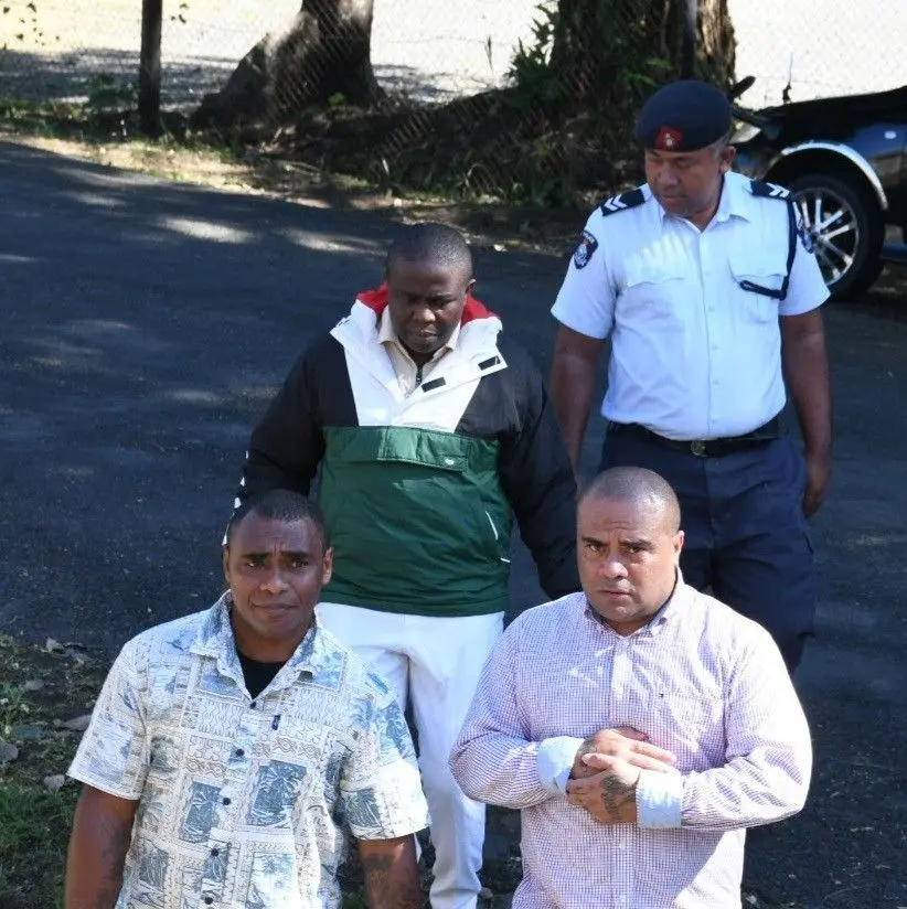  Accused Are Tania, Viliame Nalagi and Nigerian nationals, Chukwuemeka Phabian, escorted by a police officer outside the High Court of Lautoka. 