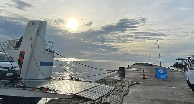 Passengers disembark their vehicles from a ship while berthed at the Levuka Wharf.