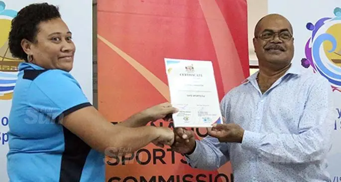 Netball Fiji Vice President Development Lupe Drasuna receiving their Safe Sports Fiji Sports Accredation certificate from the Permanent Secretary for the Ministry of Youth and Sports Maritino Nemani at the Nasoqo House conference room in Suva on July 9,2020. Photo: Sereana Salalo.