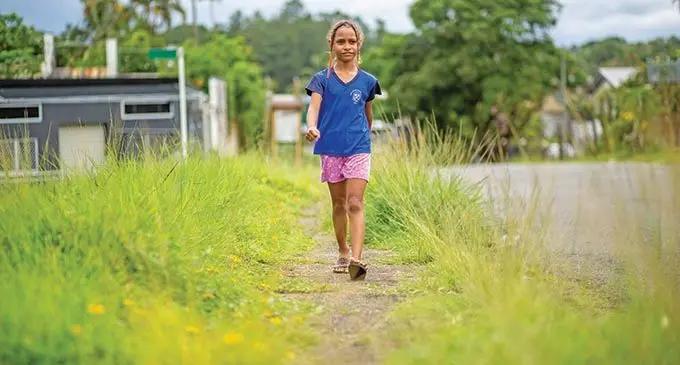 Kristelle Tuitoga 8, passes unattended grass normally cut by Nasinu Town Councial along Vere Street at Laucala Beach on January 4, 2021. Photo: Leon Lord