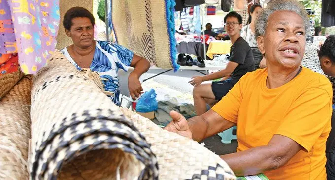 Eleni Kaloulia (yellow T -shirt) of Amania Women's Group of Wainibuka, Tailevu, during the Market day at Civic Centre carpark in Suva on December 19, 2024. Photo: Ronald Kumar