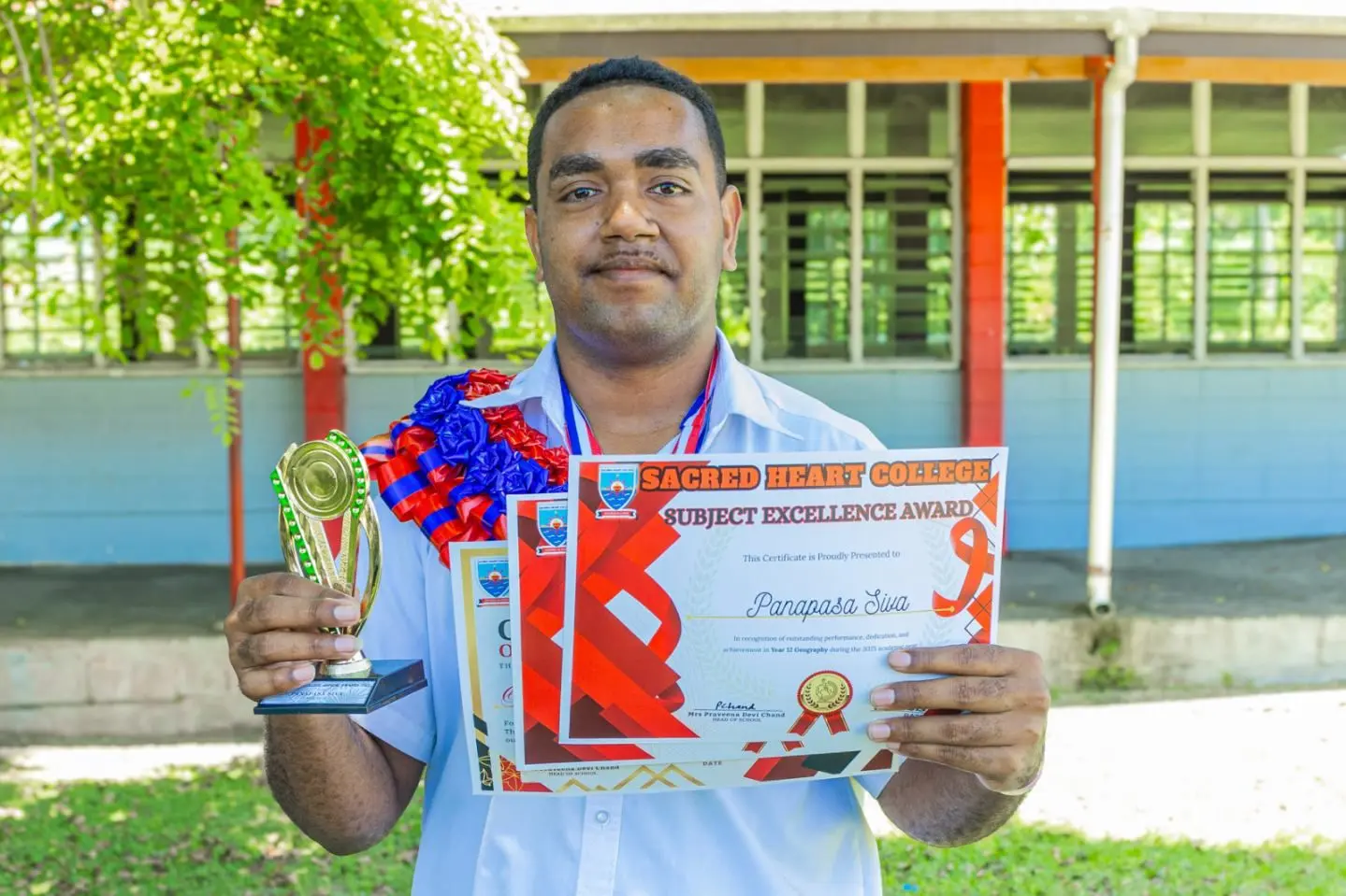 Year 12 Geography top achiever Panapasa Siva with his awards at Sacred Heart College on December 3, 2025.