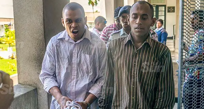 Tevita Badogo (L)  and Eroni Bale are being led by Police officersafter thier court hearing in Suva on the 20th January 2021. Photo- Leon Lord