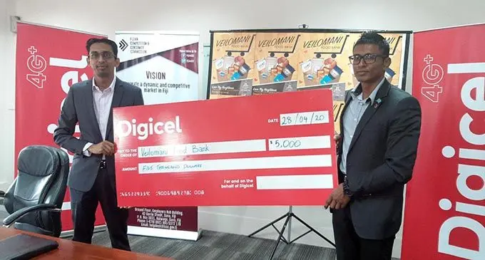 From left: Digicel chief executive officer Mohammed Farid and Fijian Competition and Consumer Commission (FCCC) chief executive officer Joel Abraham during the cheque handover of $5000 for the Veilomani Foodbank on April 28, 2020.  Photo: Fijian Competition and Consumer Commission