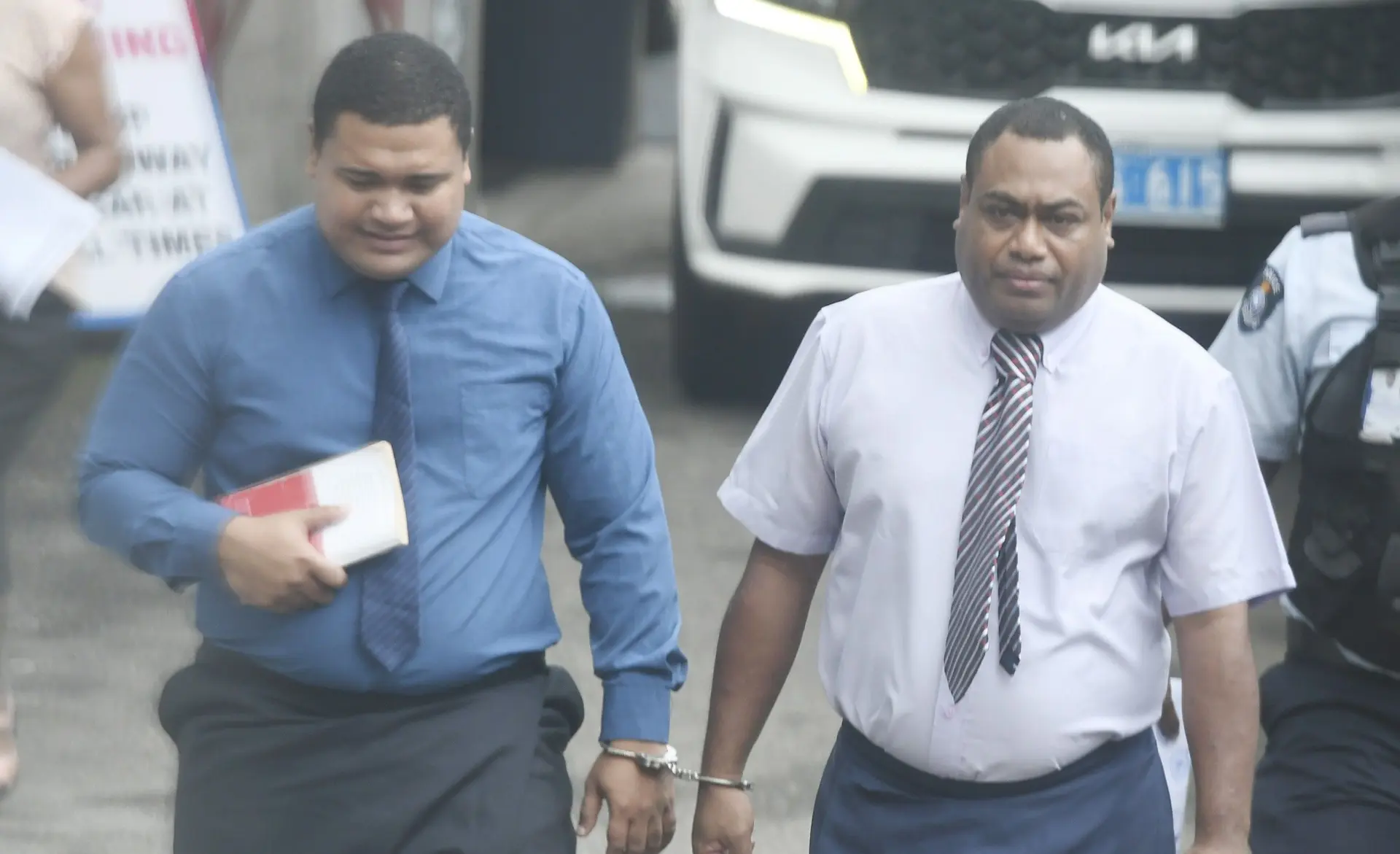 Suspended Police officers Sevoloni Lubi and Rattu Lotie Lewaivuna outside Magistrates Court in Suva on October 23, 2025.