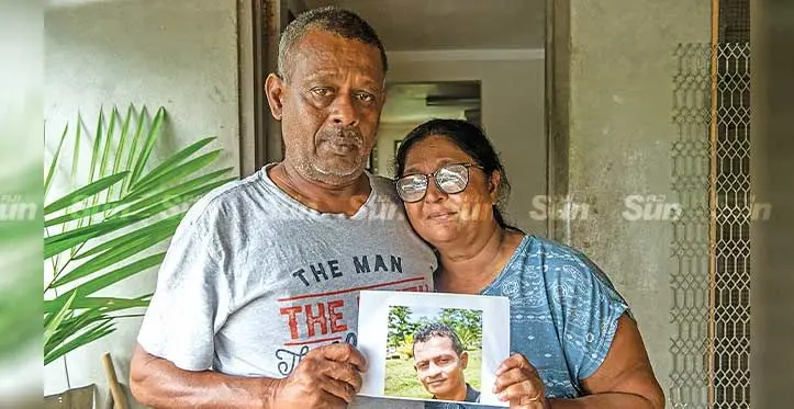 Shahenoor Mallam (left) and Mumtaz Begum hold up a photo of their late son Shameem Sajid Mallam at their home in Nadawa on April 23, 2023. Photo: Leon Lord