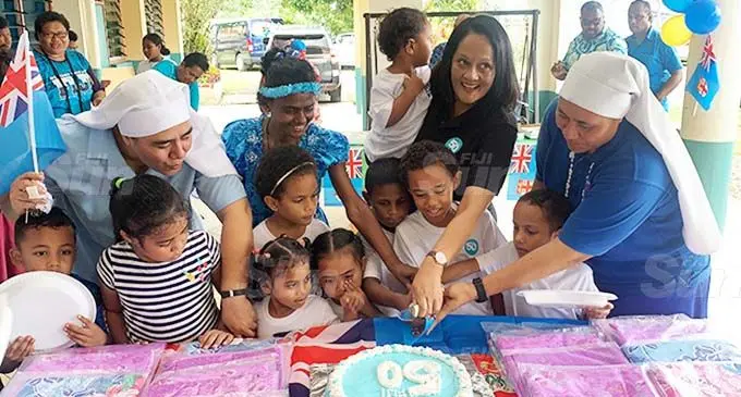 Minister for Education, Heritage and Arts Rosy Akbar holds Adi Rosela, with Sister Kalolaine Tuineau (left), Sister Vutulongo Tuinayau (right), children and staff members of St Christopher’s Home in Naulu, Nasinu, on October 10, 2020. Photo: Kelera Sovasiga
