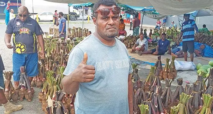 Maika Koroitamana stands infront of his batch of dalo at the Lautoka Mini bus stand car park on December 23, 2022. Photo: Salote Qalubau