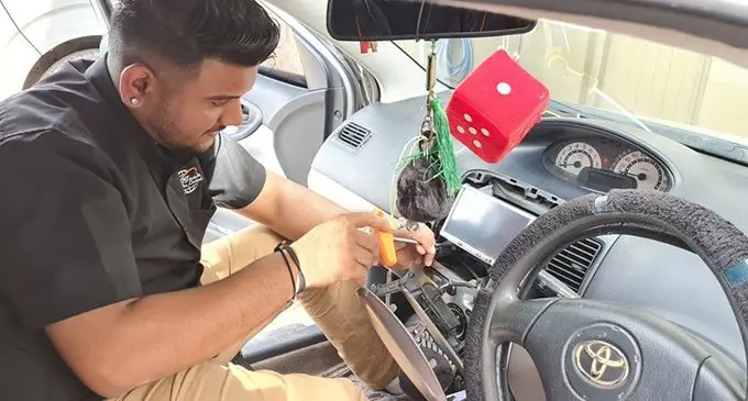 Shahil ungrading the car stereo in Vios