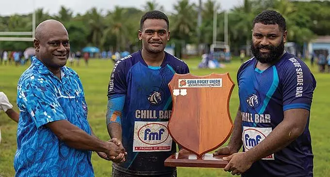 Police Blue team manager Livai Toribau (left) presents the Esala Teleni Shield to the Lami Cavaliers team at Buckhurst Park, Suva on March 9, 2024. Photo: Sereana Salalo