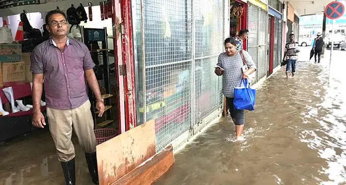 Business Owners and shoppers tread upon a flooded Labasa Town on February 3, 2023. Photo: Shratika Naidu