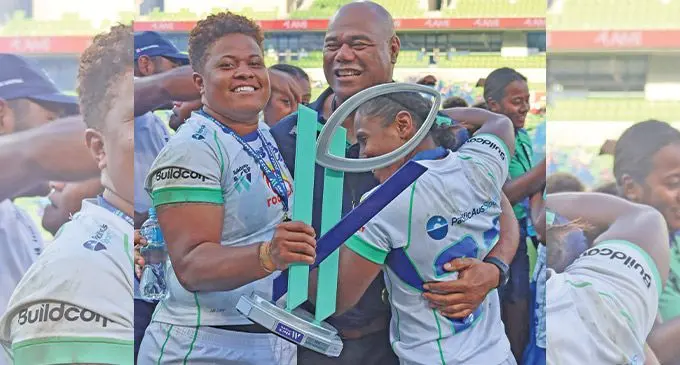 Rooster Chicken Fijiana Drua coach Senirusi Seruvakula (centre) is hugged by Vika Matarugu (left) and Reijeli Uluinayau after their Super W final win against Waratahs at AAMI Park, Melbourne, on April 23, 2022 Photo: FRU Media