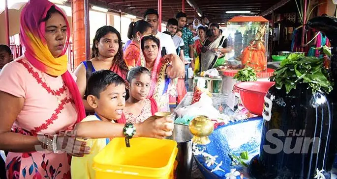 Shama Devi with her grandson, Pranshu Prasad (left) offering their Maha Shivratri prayer at Samabula Shiv Temple on February 22, 2020. Photo: Ronald Kumar