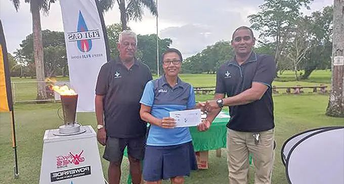 Agnes Managreve receiving the Ladies 1st Prize from John Wilson of Fiji Gas as President Vijay Madhavan looks on. Photo: Waisea Nasokia
