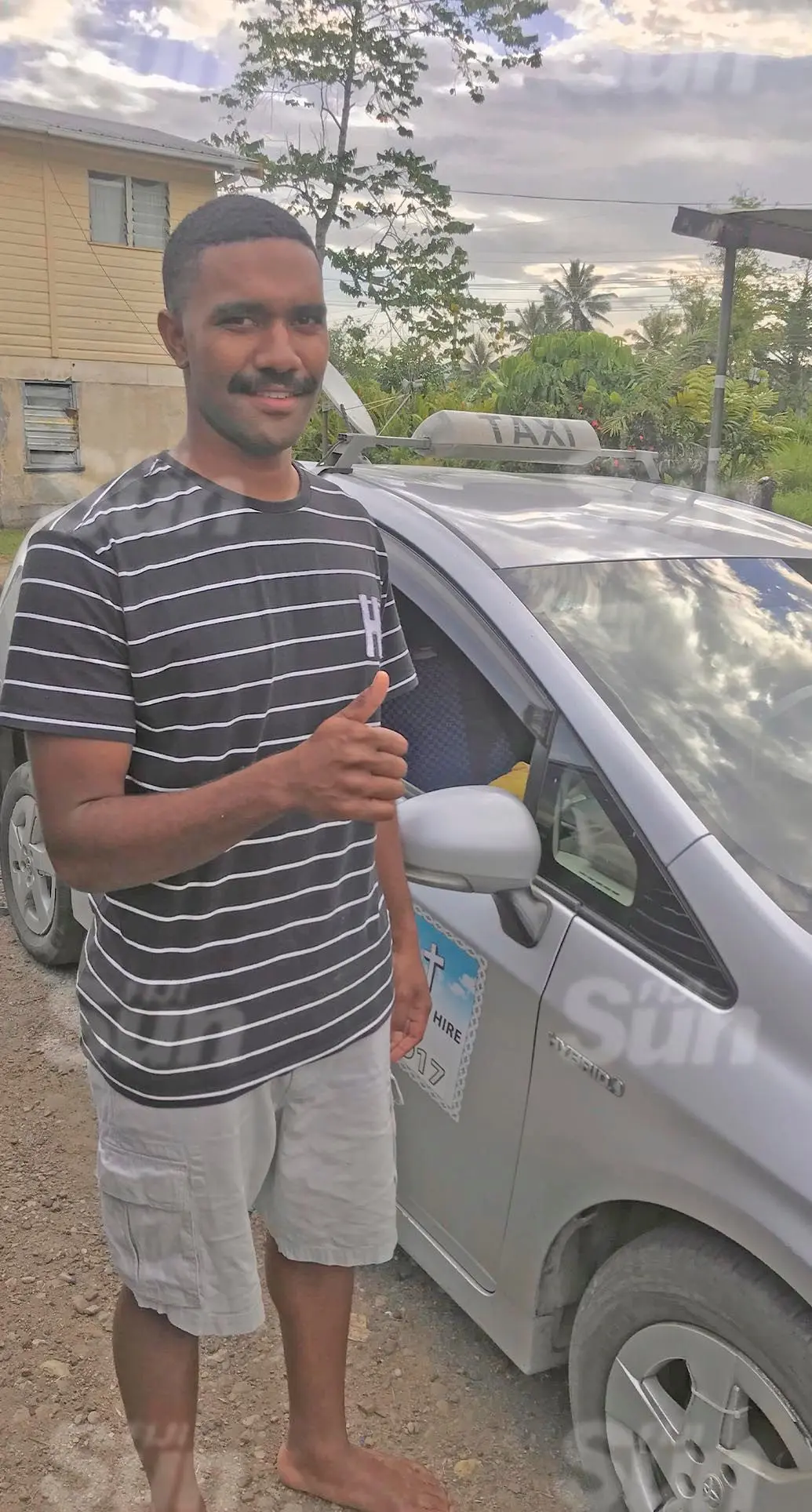 Tiko Kece taxi driver Suliasi Tubuna stands beside the cab at his home in Waila, Nausori on November 1, 2021. He was driving the cab when he chased and foiled a hit-and-run suspect at Toorak, Suva on Sunday. Photo: Inoke Rabonu